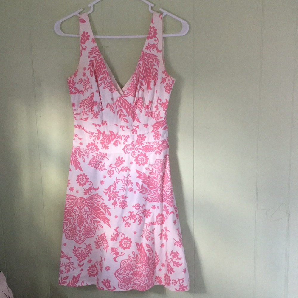 A white dress with pink design